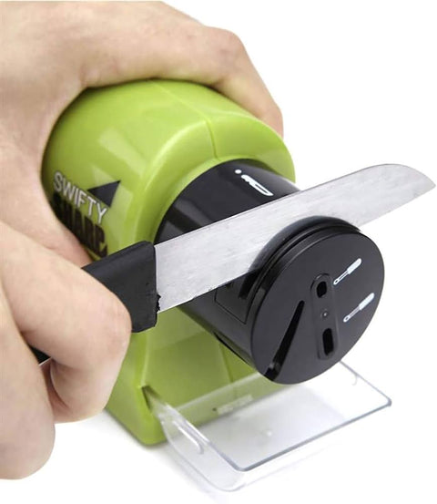 Knife sharpener with a green handle being used to sharpen a knife.